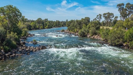 Fototapeta premium Lush Riverside Meeting Point of Two Waterways in a Serene Valley Landscape