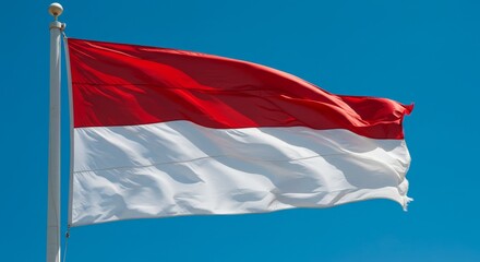 Indonesian Flag Waving Against Blue Sky