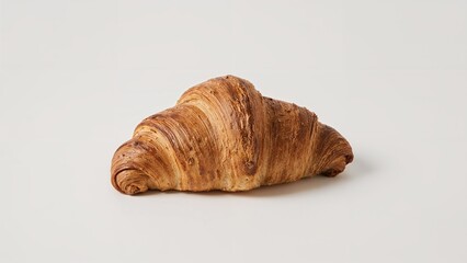 Golden brown croissant presented on a plain white background.