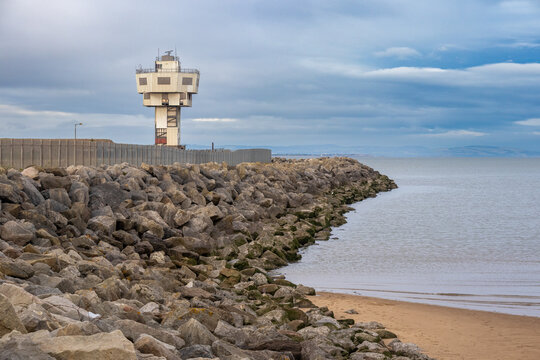Radar tower at Crosby overlooking sea defence rocks and shoreline