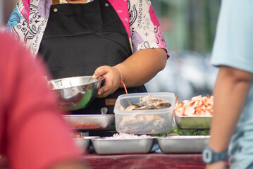 Street Vendor Preparing Fresh Seafood Dishes