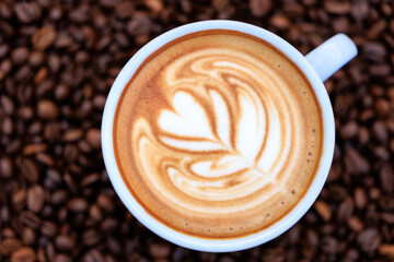 cappuccino white cup and roasted coffee beans backgrounds abstrack
