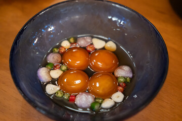 Pickled egg yolk and sauce in a cup