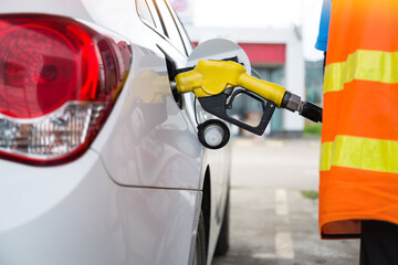 Man filling gasoline fuel in car holding pump. Close up on male hand refuel car.relatively high price during war concept.