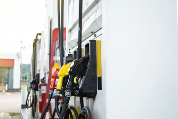 Closeup fuel dispenser gasoline fuel in car at gas station. Petrol or gasoline being pumped into a motor vehicle car.Price expensive during war.