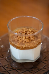 Panna Cotta in a glass cup, on the table in the restaurant