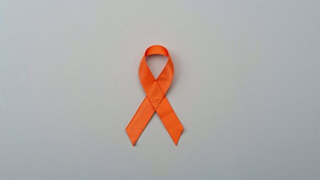 Gray backdrop with an orange awareness ribbon seen from above, text area included