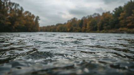 Fototapeta premium Image of a flowing river under overcast autumn skies
