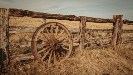 Obraz premium Rustic Ranch Setting Featuring Old Wagon Wheel