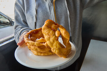Golden, crisp, and drizzled with sweet chancaca syrup, these Arequipa-style picarones are a...
