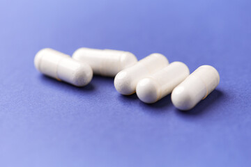 Hyaluronic acid tablets. Hyaluronic acid helps skin stretch and flex and reduces skin wrinkles. Bright paper background. Soft focus. Close up. Copy space	