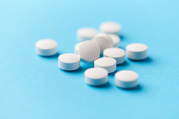 Hyaluronic acid tablets. Hyaluronic acid helps skin stretch and flex and reduces skin wrinkles. Bright paper background. Soft focus. Close up. Copy space	