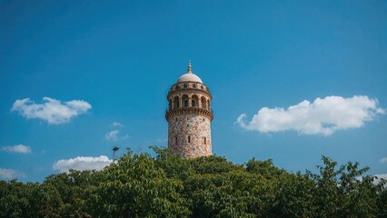 Fototapeta premium Tower adorned with mosaic patterns against a clear blue summer sky
