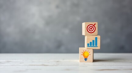 The Business Strategy - A stack of wooden blocks with icons for a target, graph, and lightbulb, symbolizing a strategic business plan and innovation