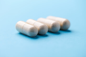 Creatine tablets on paper background. Soft focus. Close up. Copy space.	