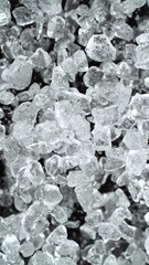 Ice Cubes. Textured Ice on a Black Background, Close-up. Abstract Background, Flying Ice. Vertical...