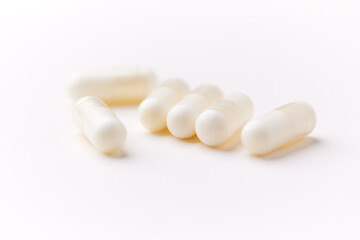 Creatine capsules on paper background. Soft focus. Close up. Copy space.	
