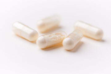 Coenzyme Q10 capsules. Antioxidants. Concept for a healthy dietary supplementation. Bright paper background. Soft focus. Close up. Copy space.	