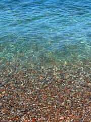 Sea and colorful pebbles on the beach.