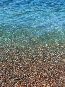 Sea and colorful pebbles on the beach.