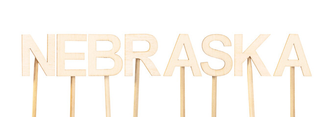 Name of the state Nebraska formed with individual wooden letters, a minimalist style ideal for educational resources or editorial design focused on the central region of the US