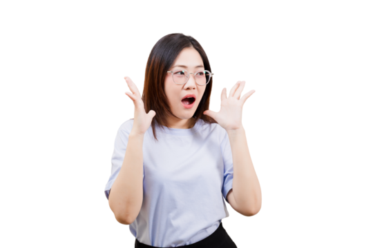 A surprised Asian young beautiful woman with glasses raises her hands in a shocked expression, displaying a strong emotional reaction.