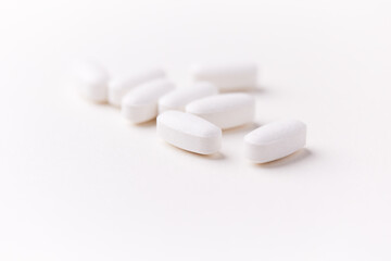 Creatine capsules on paper background. Soft focus. Close up. Copy space.	