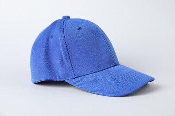 One blue baseball cap on grey background, closeup. Mockup for design