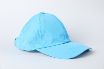 One light blue baseball cap on grey background, closeup. Mockup for design