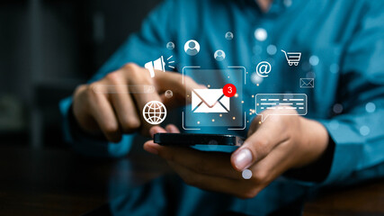 Businessman using smartphone for email communication with digital marketing icons, sending messages online, social media connection, business technology, and professional networking concept.
