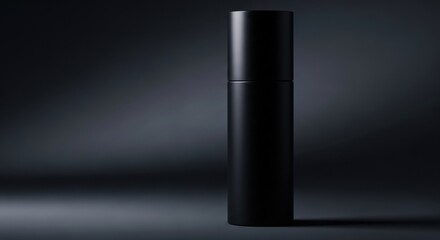 Fototapeta premium Elegant matte black cylindrical bottle for premium skincare products or perfume, shown on a dark, dramatic background.