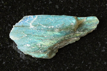 sample of raw green labradorite mineral on black