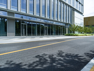 enpty asphalt road with modern office building