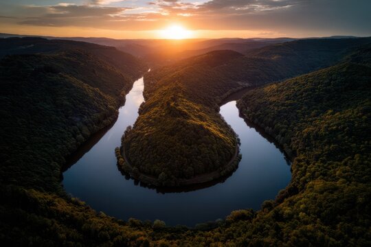 Dramatic horseshoe bend river at sunset with golden sky