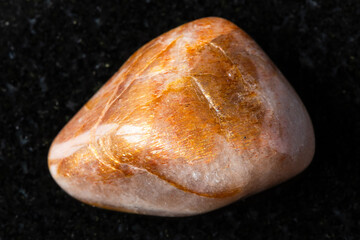 sample of tumbled iridescent feldspar on black