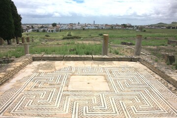 The Roman ruins of Italica. Italica, near Seville, Spain, was an ancient Roman city.  The Roman ruins of Italica feature remarkable mosaics and an impressive amphitheatre.