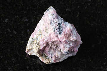 sample of raw pyroxmangite mineral on black