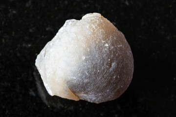 sample of uncut agate mineral on black granite