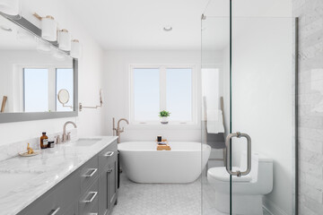 A bathroom with a grey vanity cabinet, white marble countertop, marble hexagon tile flooring, and a white freestanding tub with a bronze faucet.