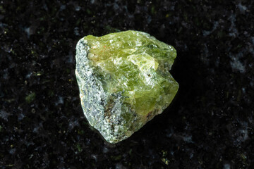 sample of raw green sphene mineral on black