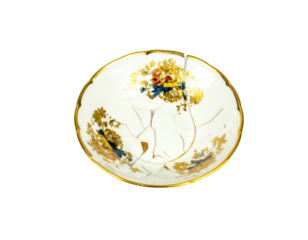 A shattered teapot lid, isolated on a white background, perfect for use in themes of damage, broken kitchenware, or repair.