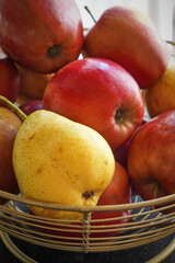 Mixed apples and pears in a glass bowl for simple fruit presentation