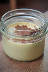 Individual dessert jar with creamy interior and decorative sprinkle