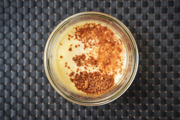 Single ramekin of caramelized custard ready for serving as a dessert