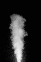 Cloud of white dust particles floating in dark air on black background. Swirling, writhing smoke to...