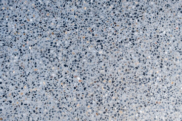 A grey and white tile floor with many small stones