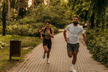 Couple running in park enjoying exercise together