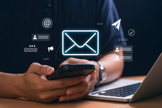 Businessman using a smartphone for an email marketing campaign, sending newsletters, and managing online communication with virtual icons. - Powered by Adobe