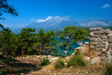 The remains of the walls of the ancient city of Phaselis in Lycia against the background of the Mediterranean bay in modern Turkey.