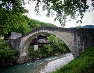 Fototapeta premium A picturesque village bridge over a river, representing themes of travel, nature, and traditional architecture.